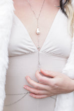 Load image into Gallery viewer, Close-up of a person wearing a white dress with a decorative chain detail on a light background.
