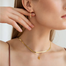 Load image into Gallery viewer, golden brown music earrings on a model
