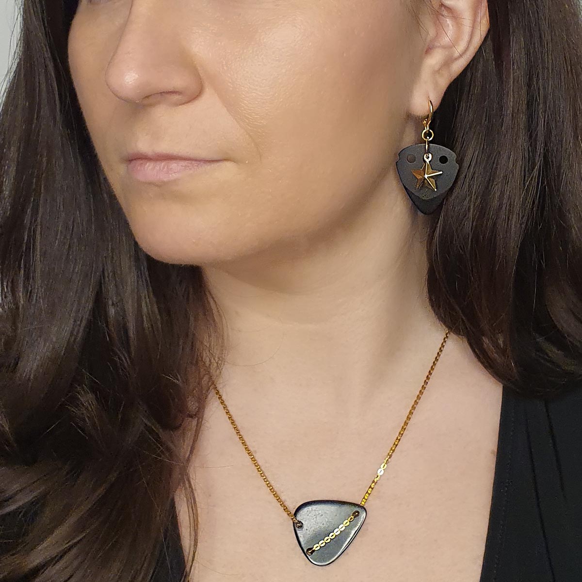 model-wearing-black-guitar-pick-with-gold-star-pendant-earrings.jpg