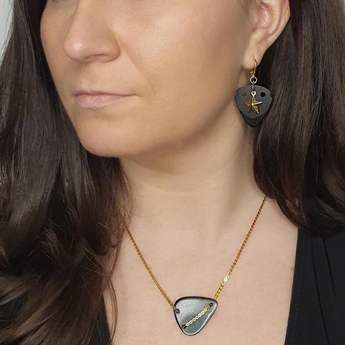 model-wearing-black-guitar-pick-with-gold-star-pendant-earrings.jpg