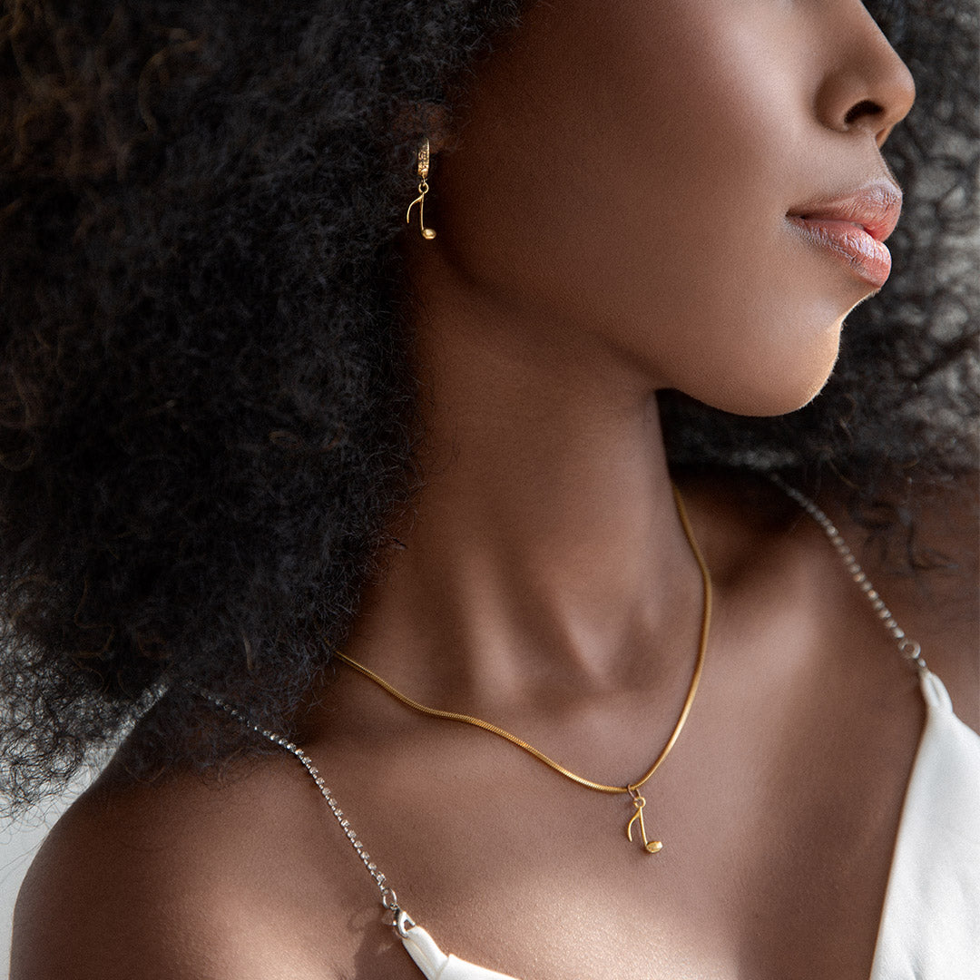glitter aint gold earrings on a dark skin model